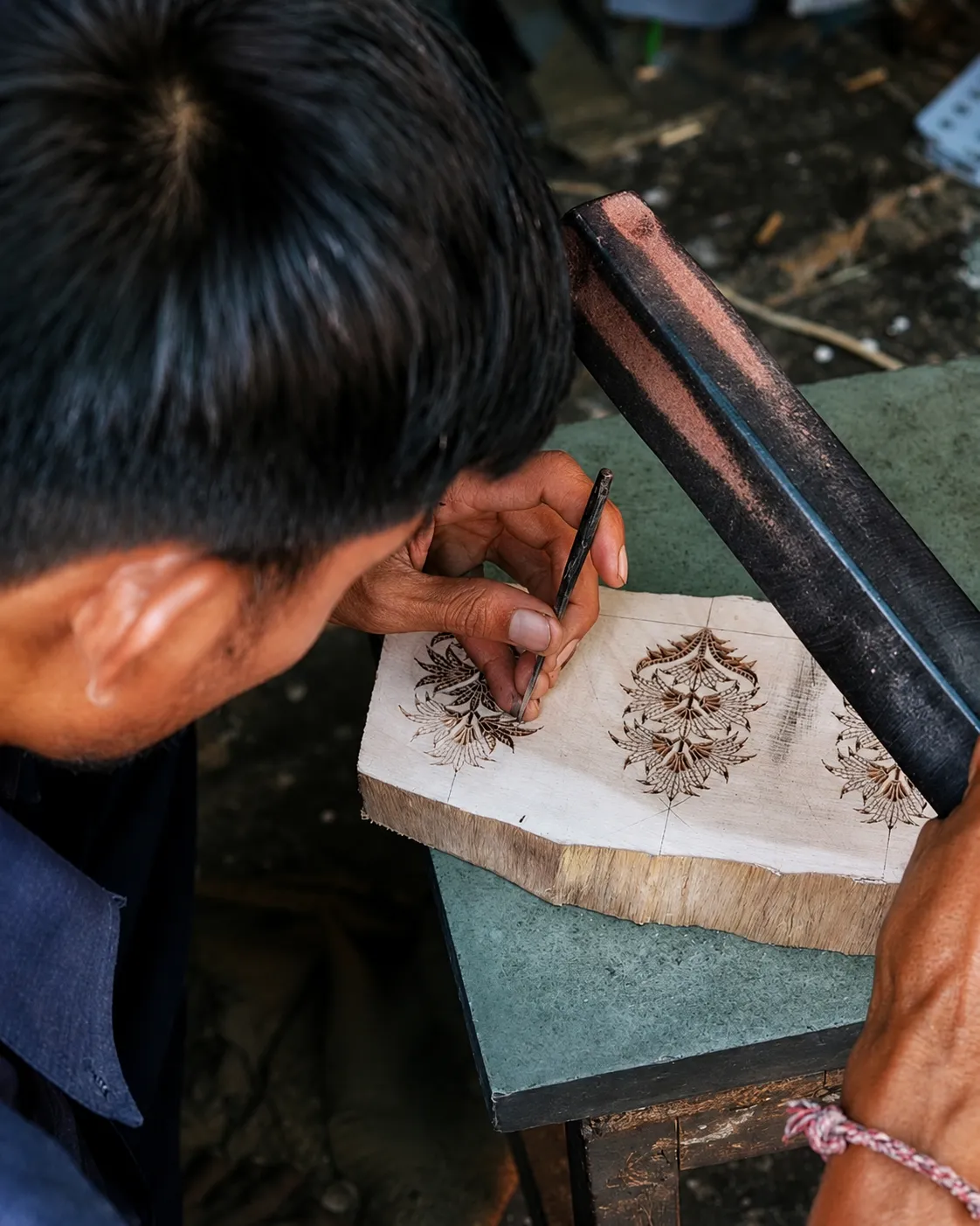 Artisan carving a wooden block